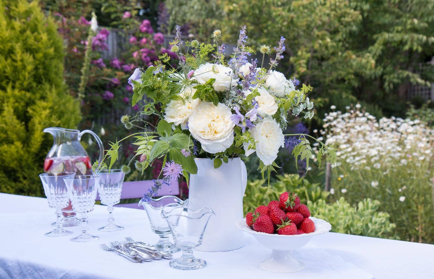 Summer Outdoors Party With Cream Roses Strawberries and Champagne