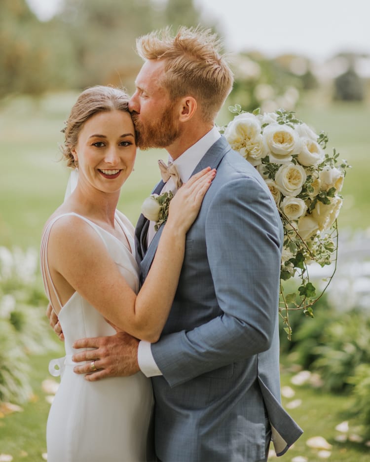 Sposa e sposo con bouquet da sposa